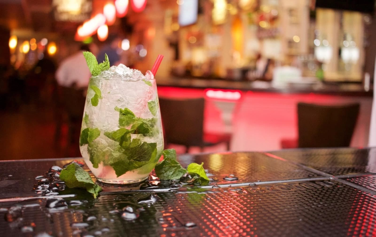 A drink on a lit bar counter