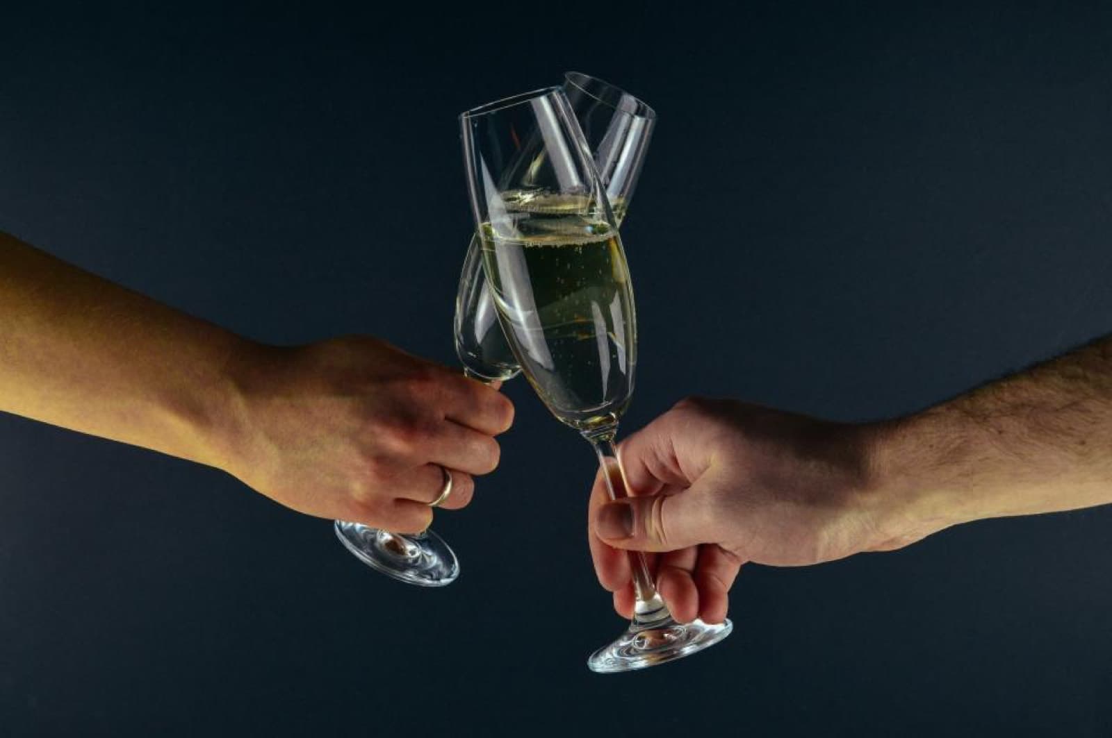 Two people clinking glasses